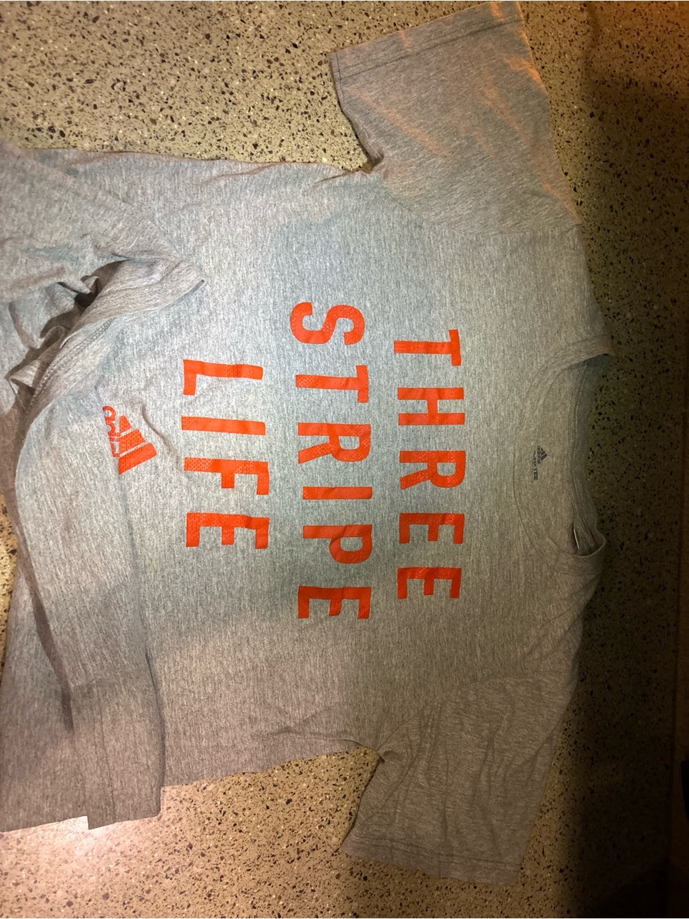 adidas Menโs Gray Crewneck Tee with Orange 'Three Stripe Life' Print